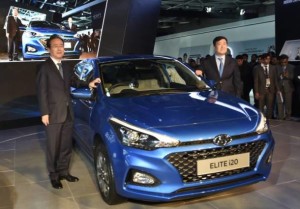 Greater Noida: Hyundai Motor India Ltd (HMIL) MD and CEO YK Koo (R), along with a company official, showcases  premium compact hatchback Elite i20 at Auto Expo 2018 in Greater Noida, Uttar Pradesh on Wednesday. PTI Photo by Kamal Singh  (PTI2_7_2018_000040A)
