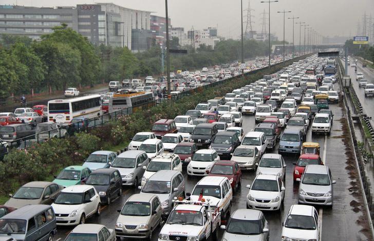 Heavy traffic moves along a busy road as it rains during a power-cut at the toll-gates at Gurgaon on the outskirts of New Delhi July 31, 2012. REUTERS/Stringer/Files